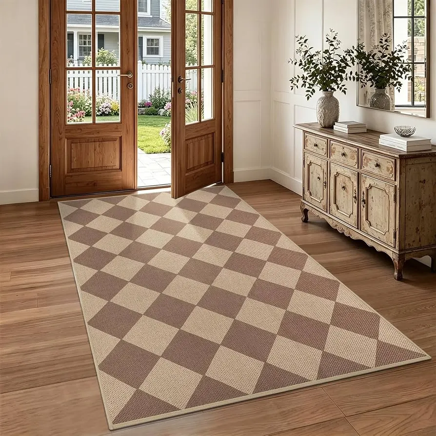 Brown and tan checkerboard rug in an entryway, from Lo’s linked ShopMy listing